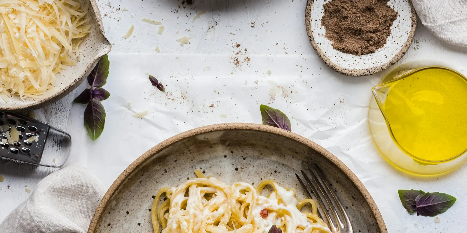 A plate of spaghetti with basil, shot from above