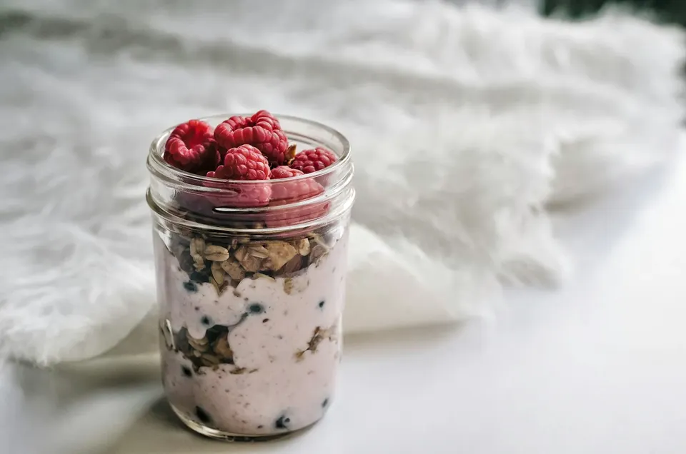 Overnight oats in a mason jar topped with raspberries